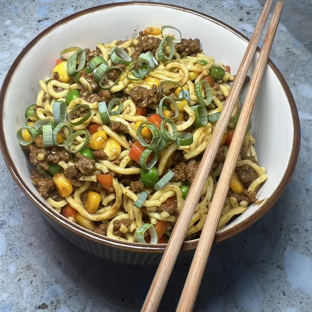 Beef and vegetable noodles topped with spring onion